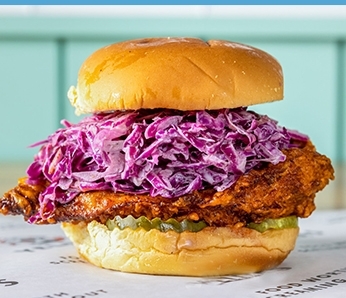 Nashville Hot chicken sandwich with Crispy Nashville-Spiced Chicken Breast, Coleslaw, Pickles on a Potato Roll