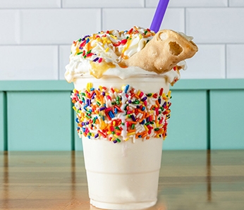 Yella's Birthday milkshake made with Vanilla ice cream, Rainbow Sprinkles, Whipped Cream, Caramel Sauce, Birthday Cake Cannoli