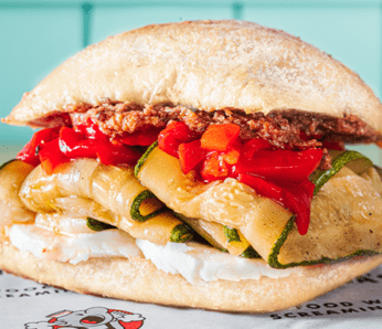 The Veggie deli sandwich with Grilled Green Zucchini, Roasted Peppers, Fresh Mozzarella, Yella's Signature Artichoke Spread on a Ciabatta bun